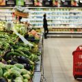 Young woman shopping in a food shop with big basket