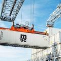 Reefer container being moved by a crane