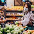 Woman wearing face mask and shopping in grocery store